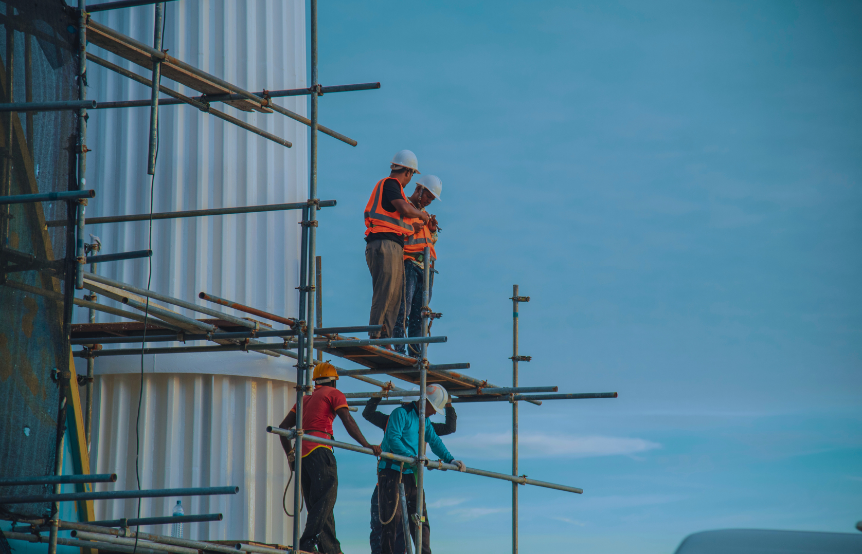 Construction crew working at height on scaffolding